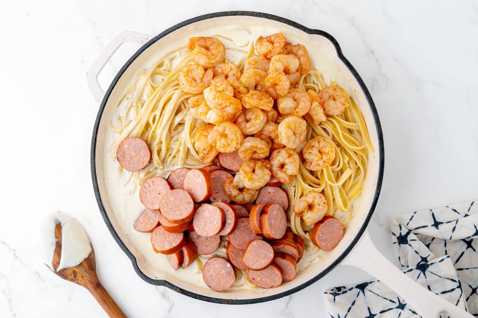 shrimp and sausage in pasta and white sauce