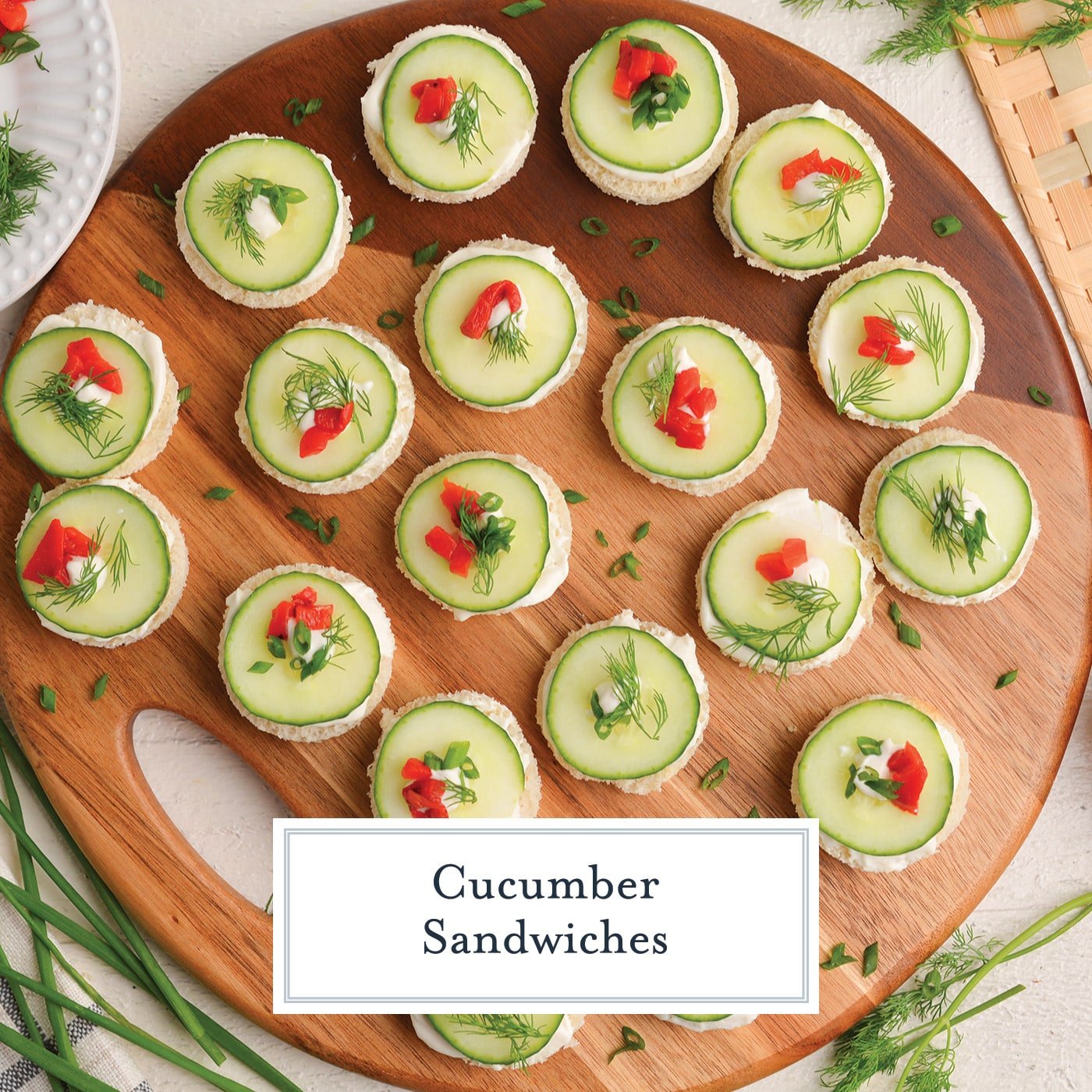 overhead shot of board of cucumber sandwiches with text overlay for facebook