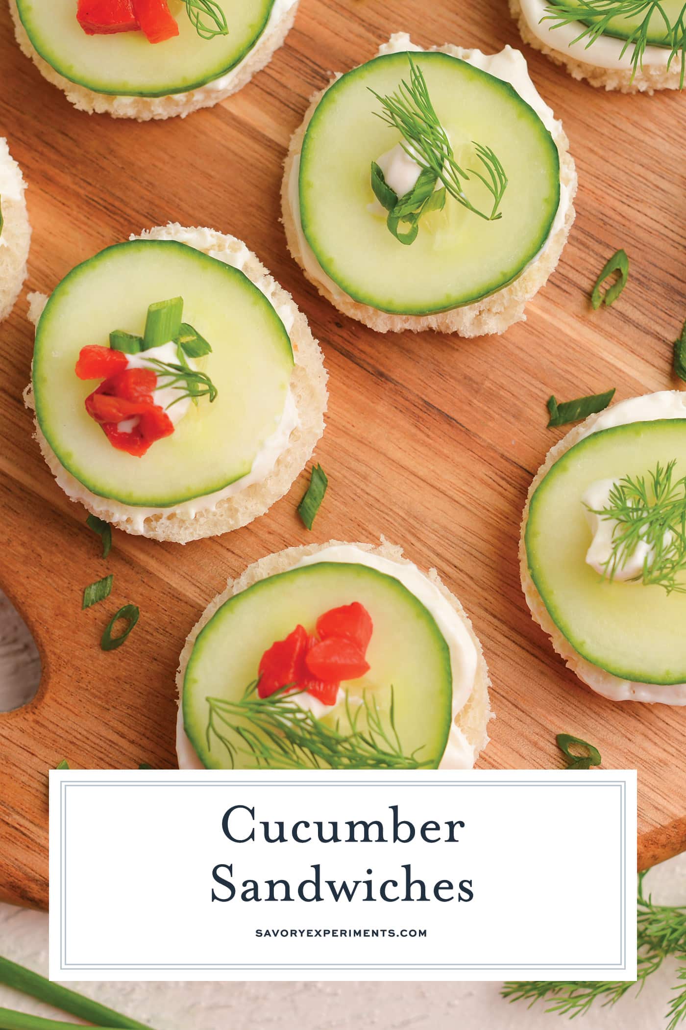 overhead shot of cucumber sandwiches on cutting board with text overlay for pinterest