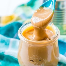 spoon in jar of dulce de leche