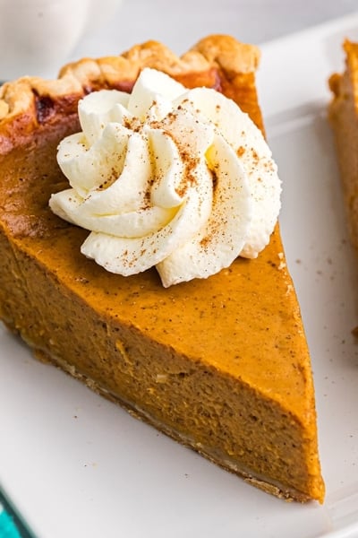 angled shot of slice of pumpkin pie