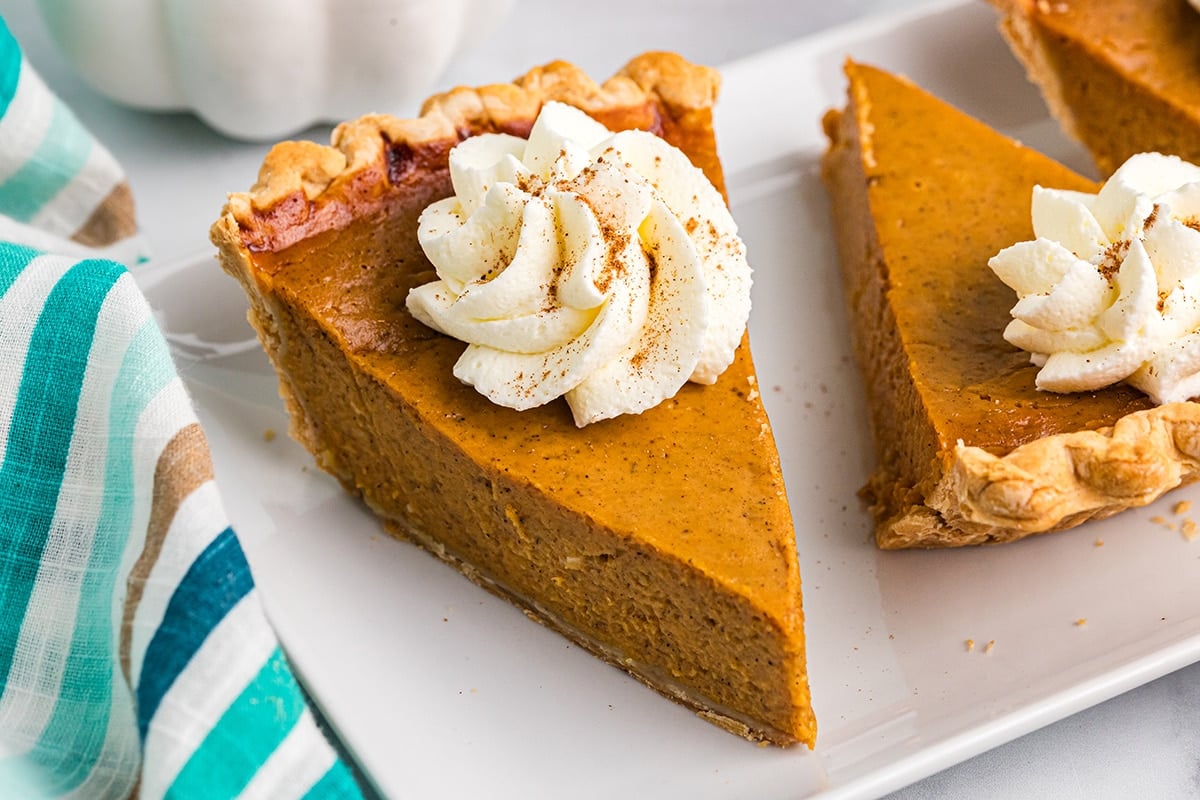 angled shot of slice of pumpkin pie