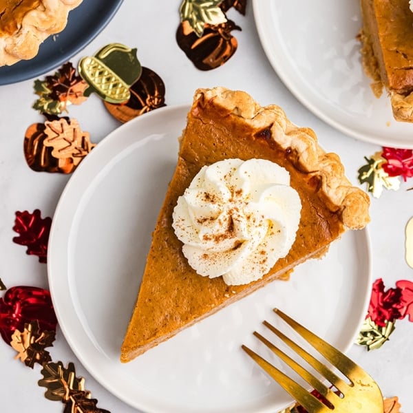 overhead shot of slice of easy pumpkin pie topped with whipped cream