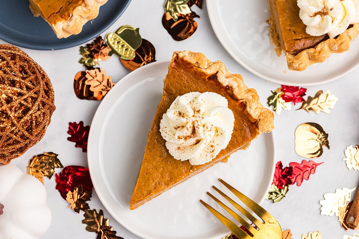 overhead shot of slice of easy pumpkin pie topped with whipped cream