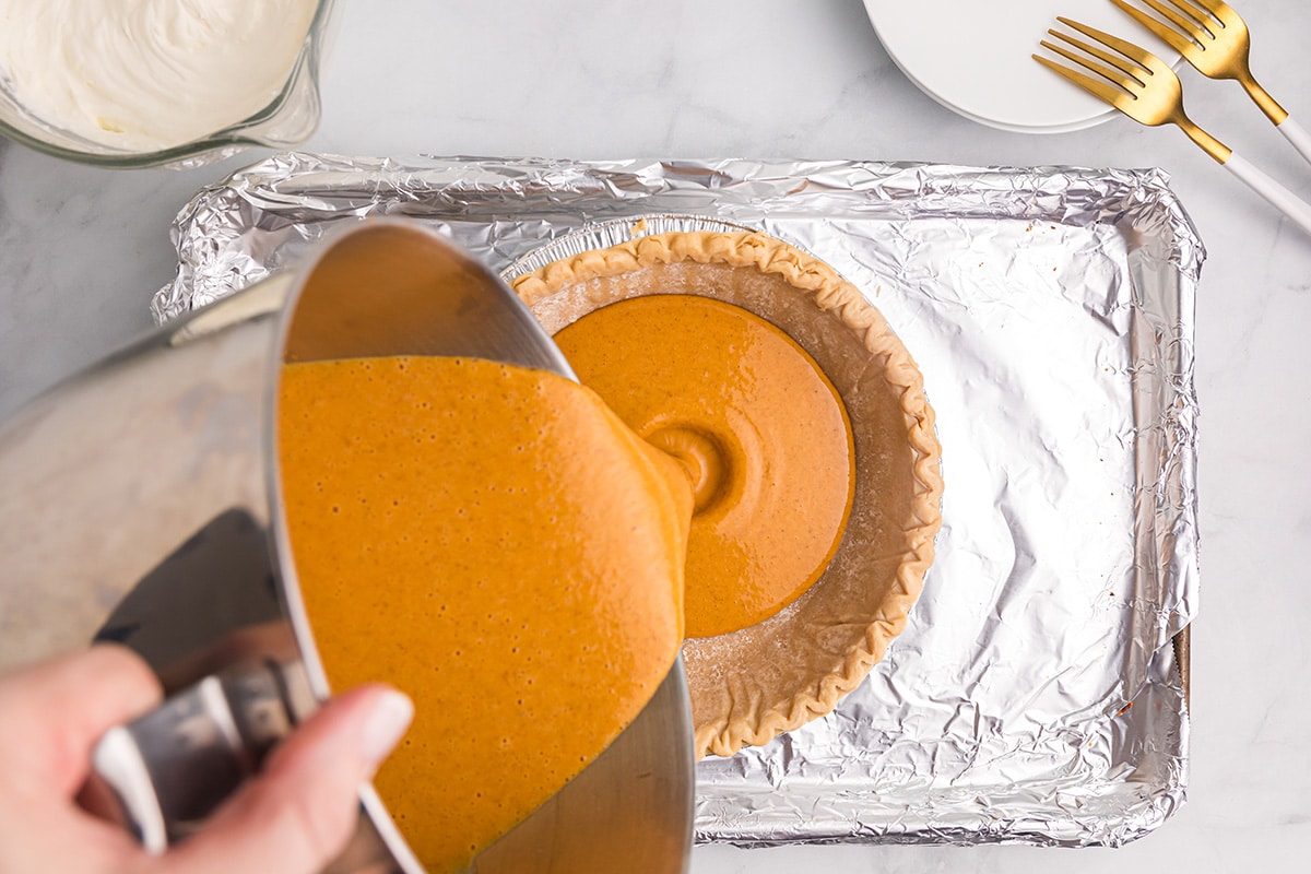 pumpkin pie filling poured into crust