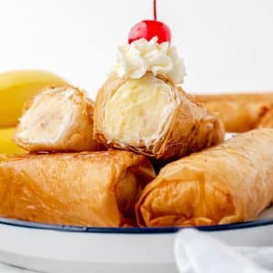 fried cheesecake cut in half stacked on a plate