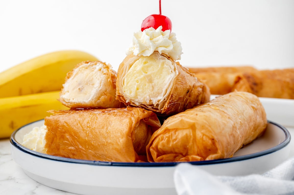 fried cheesecake cut in half stacked on a plate