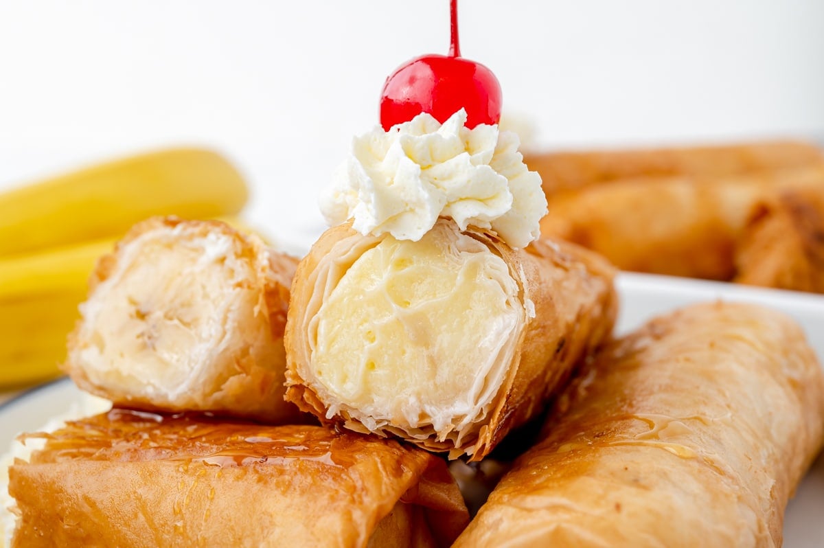 close up of fried cheesecake roll cut in half