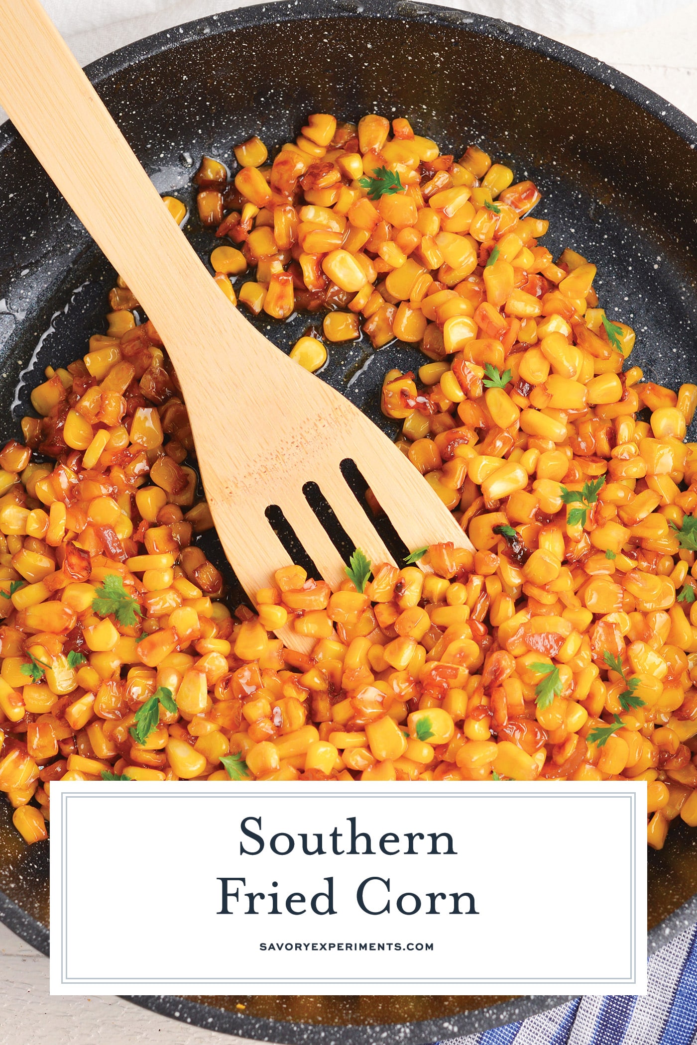 wooden spoon in pan of southern fried corn with text overlay for pinterest