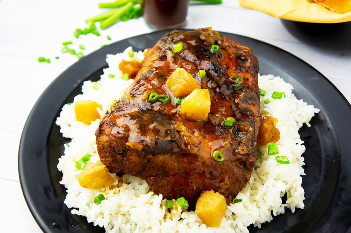 pork roast over rice on plate