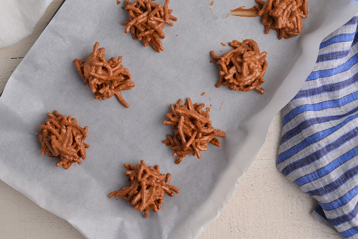 overhead shot of haystack cookies on sheet pan with parchment paper