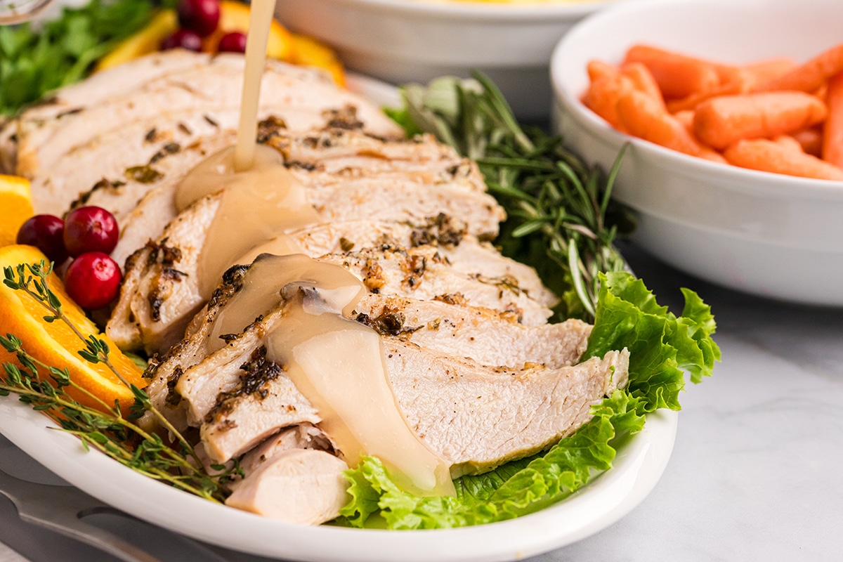 gravy poured onto sliced roast turkey breast