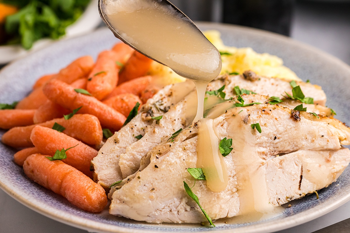 gravy spooned onto sliced roast turkey breast