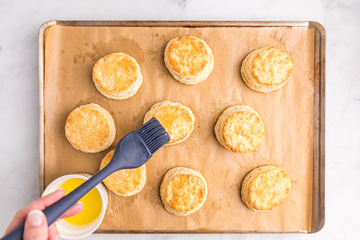 basting cooked biscuits with melted butter