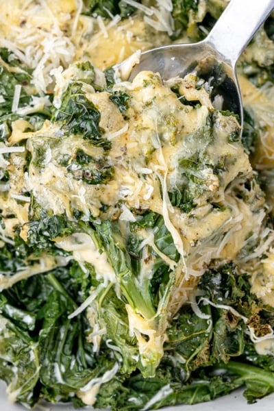 serving spoon scooping kale gratin from pan