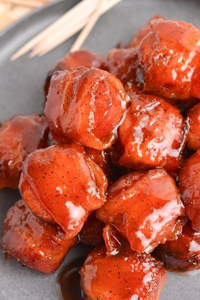 close up angled shot of kielbasa bites on a plate