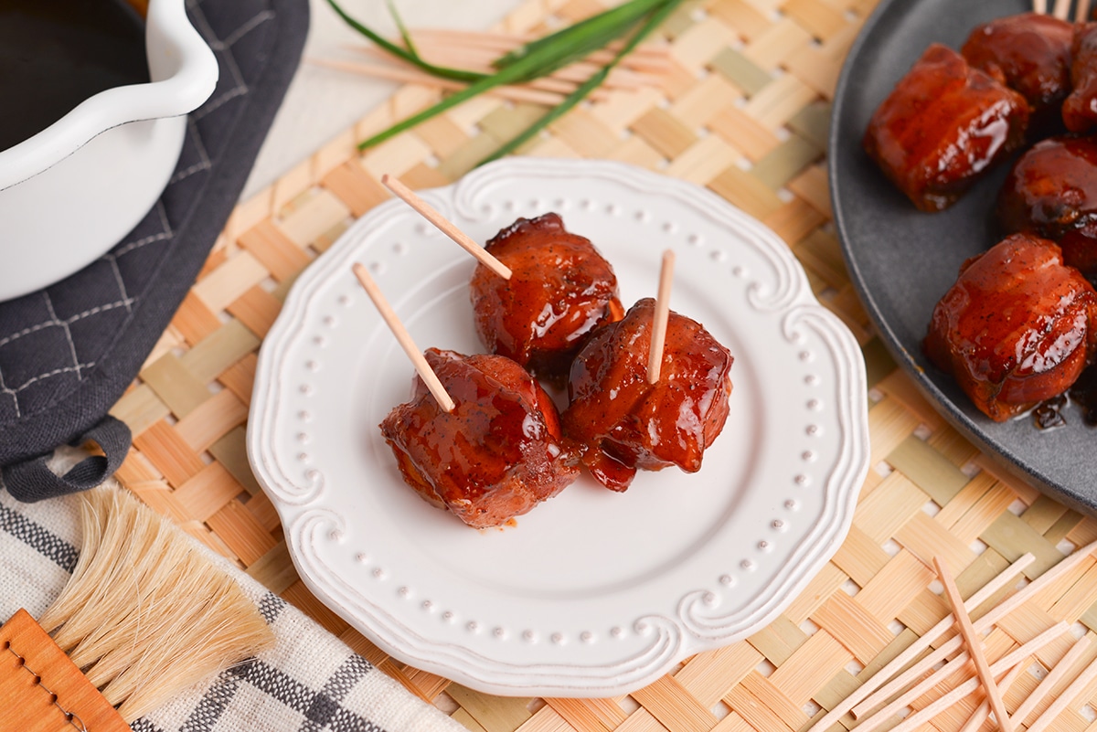 overhead shot of brown sugar bacon wrapped kielbasa bites on a plate