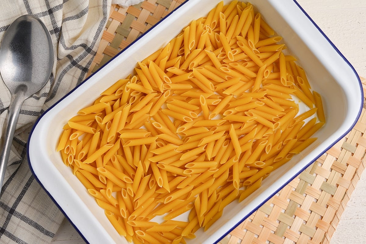 uncooked pasta in a 9x13 baking dish