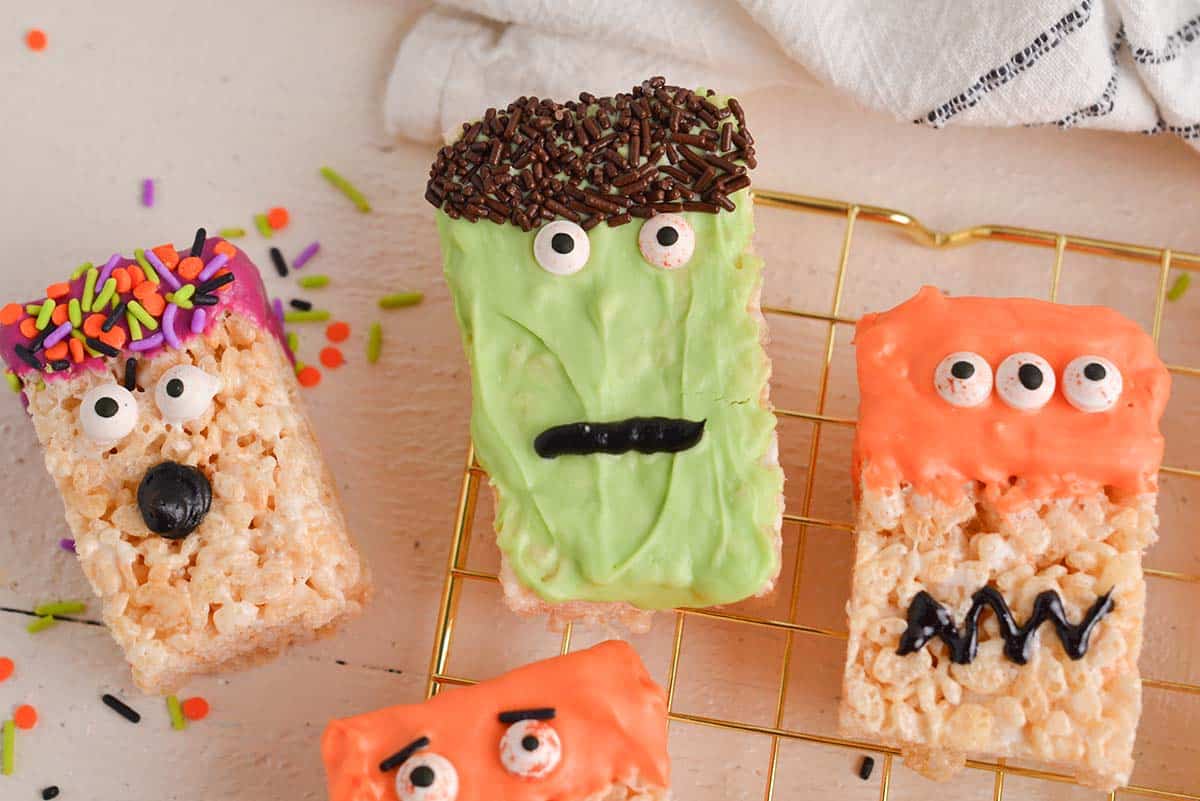 close up of three halloween rice krispie treats on a cooling rack