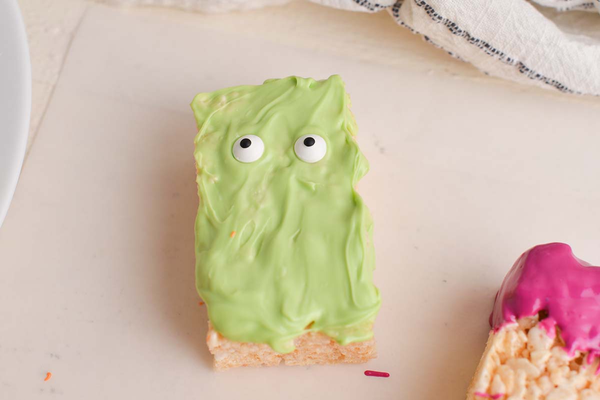 rice krispie treat covered in green chocolate with eyes