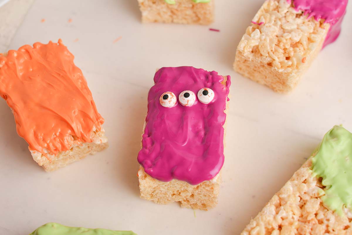 rice krispie treat covered in purple chocolate with eyes