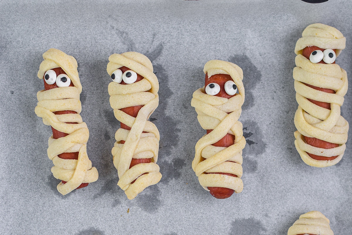 overhead shot of mummy hot dogs on parchment paper