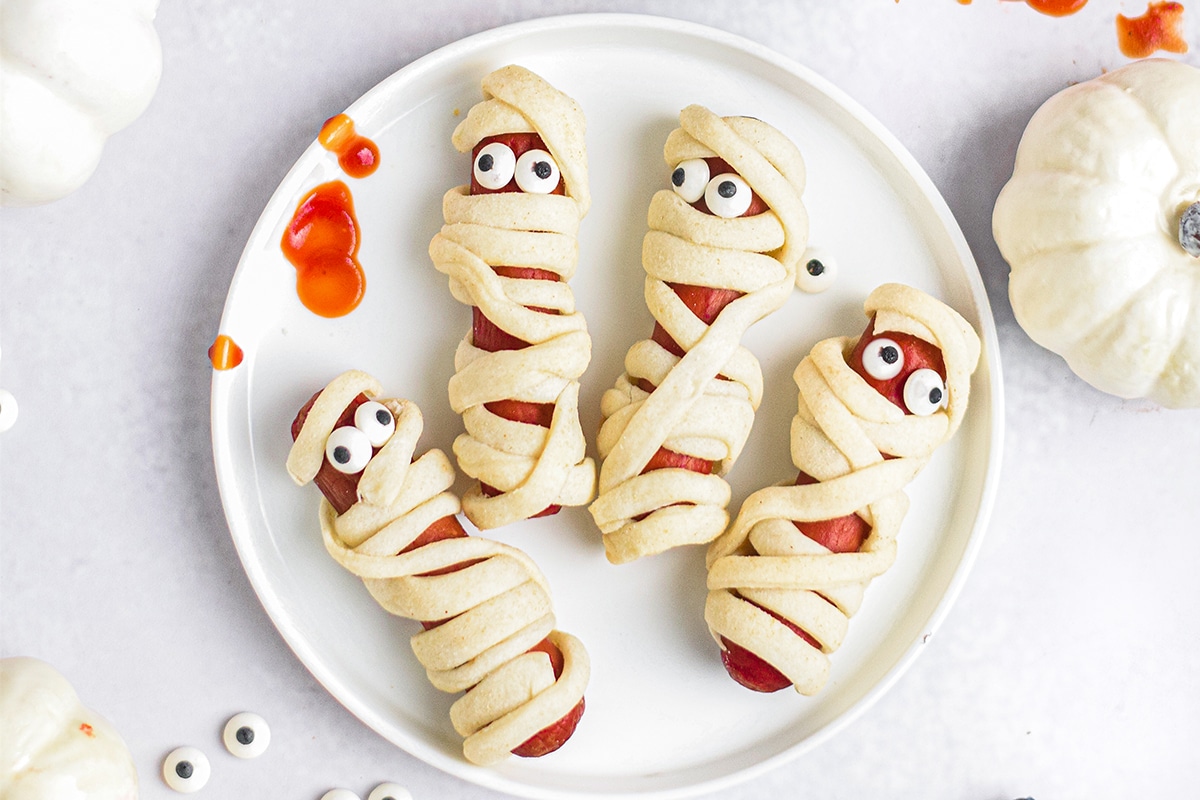 overhead shot of hot dog mummies on plate