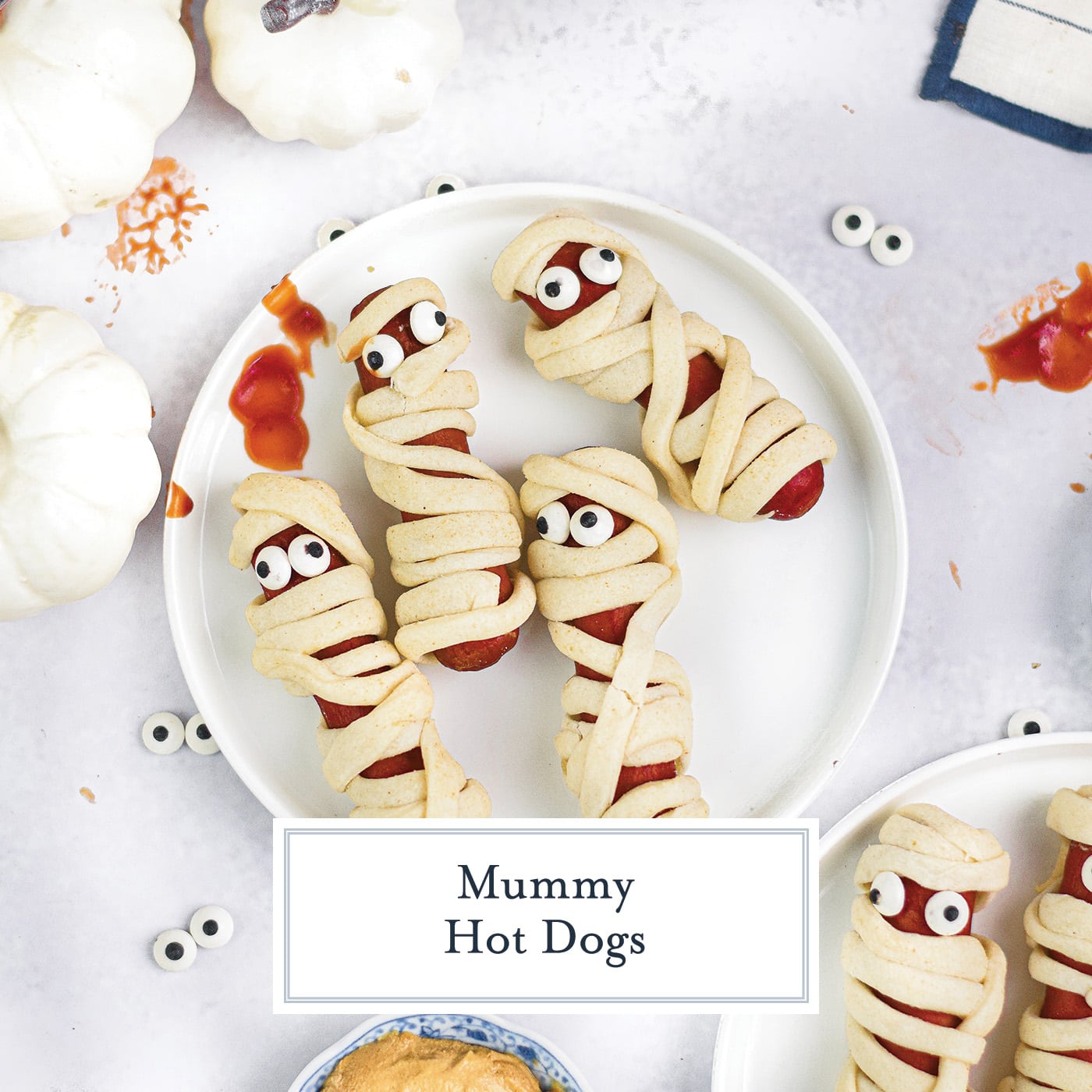 overhead shot of plate of hot dog mummies with text overlay for facebook