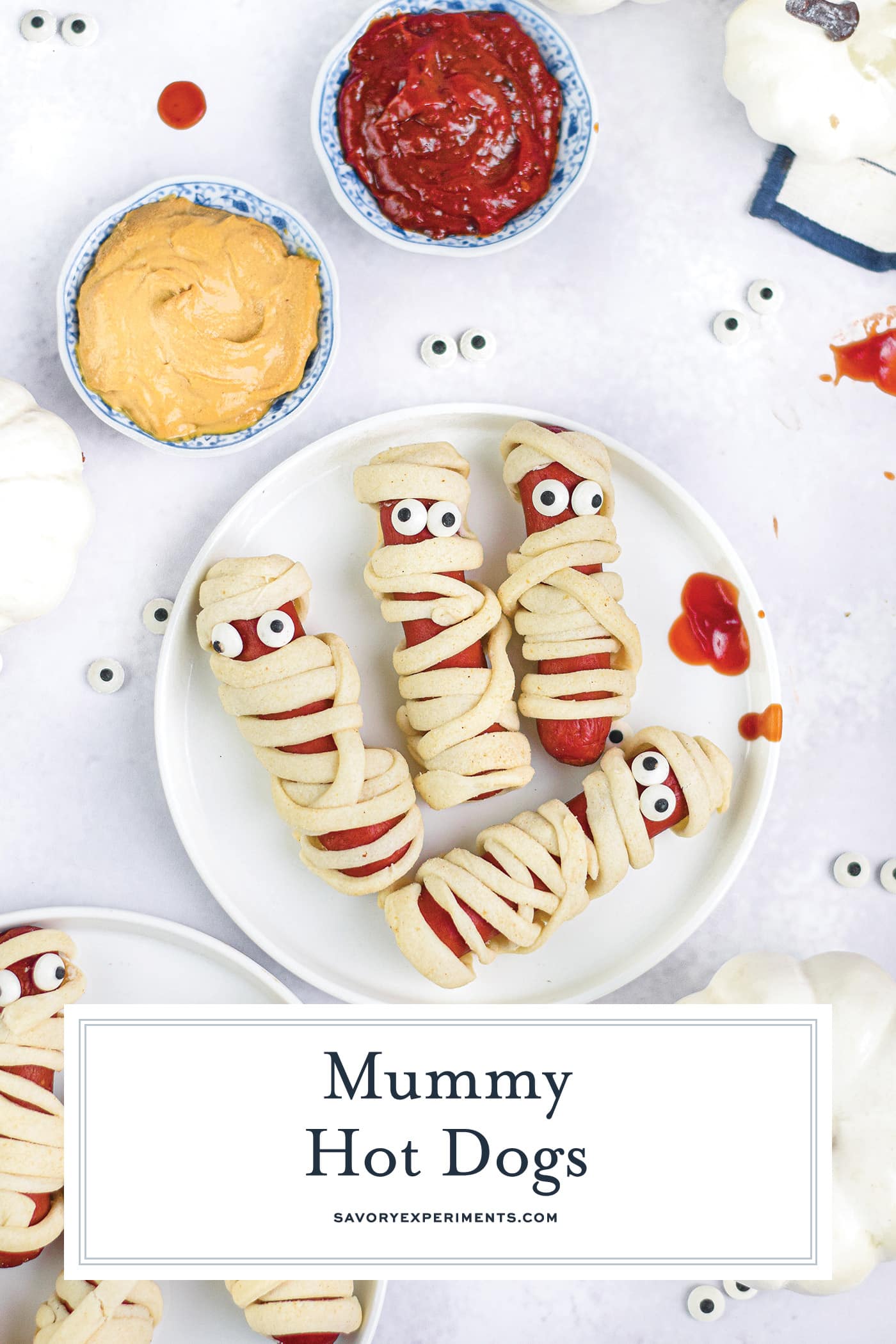 overhead shot of plate of mummy hot dogs with text overlay for pinterest