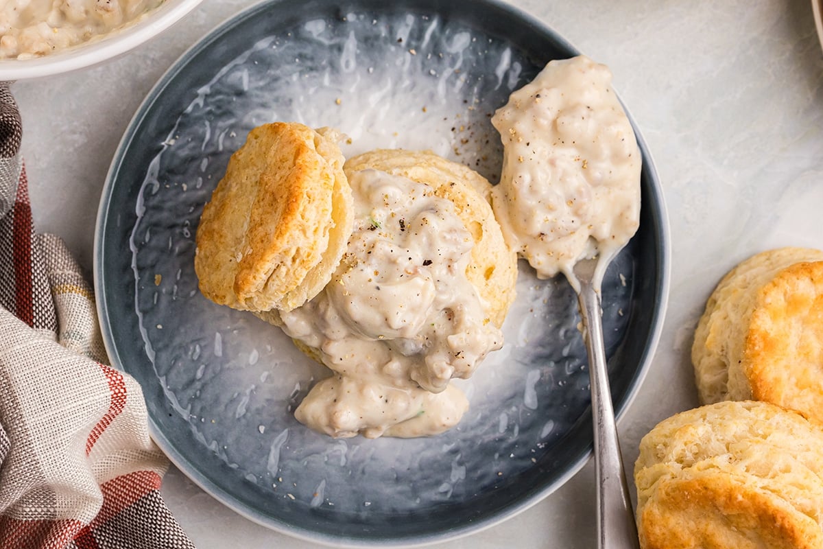 overhead shot of biscuits and gravy on plate with spoon