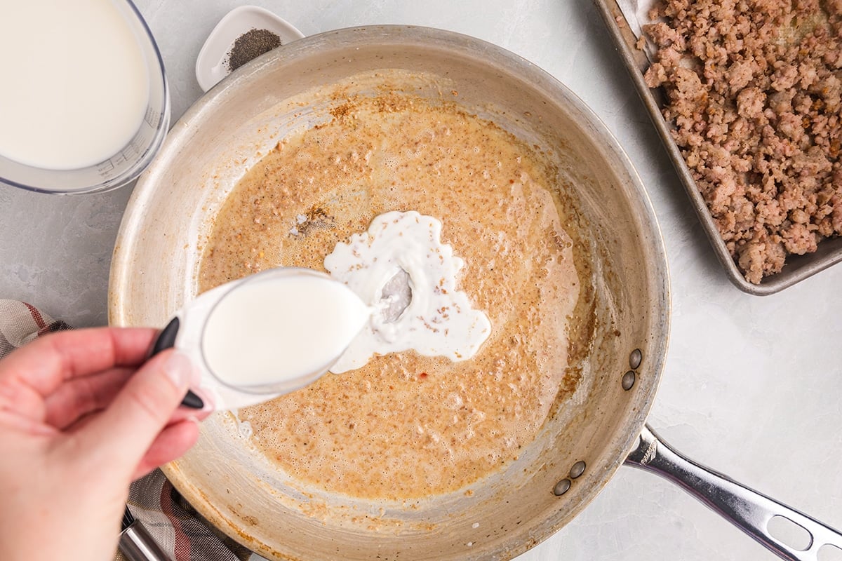 milk poured into roux in pan