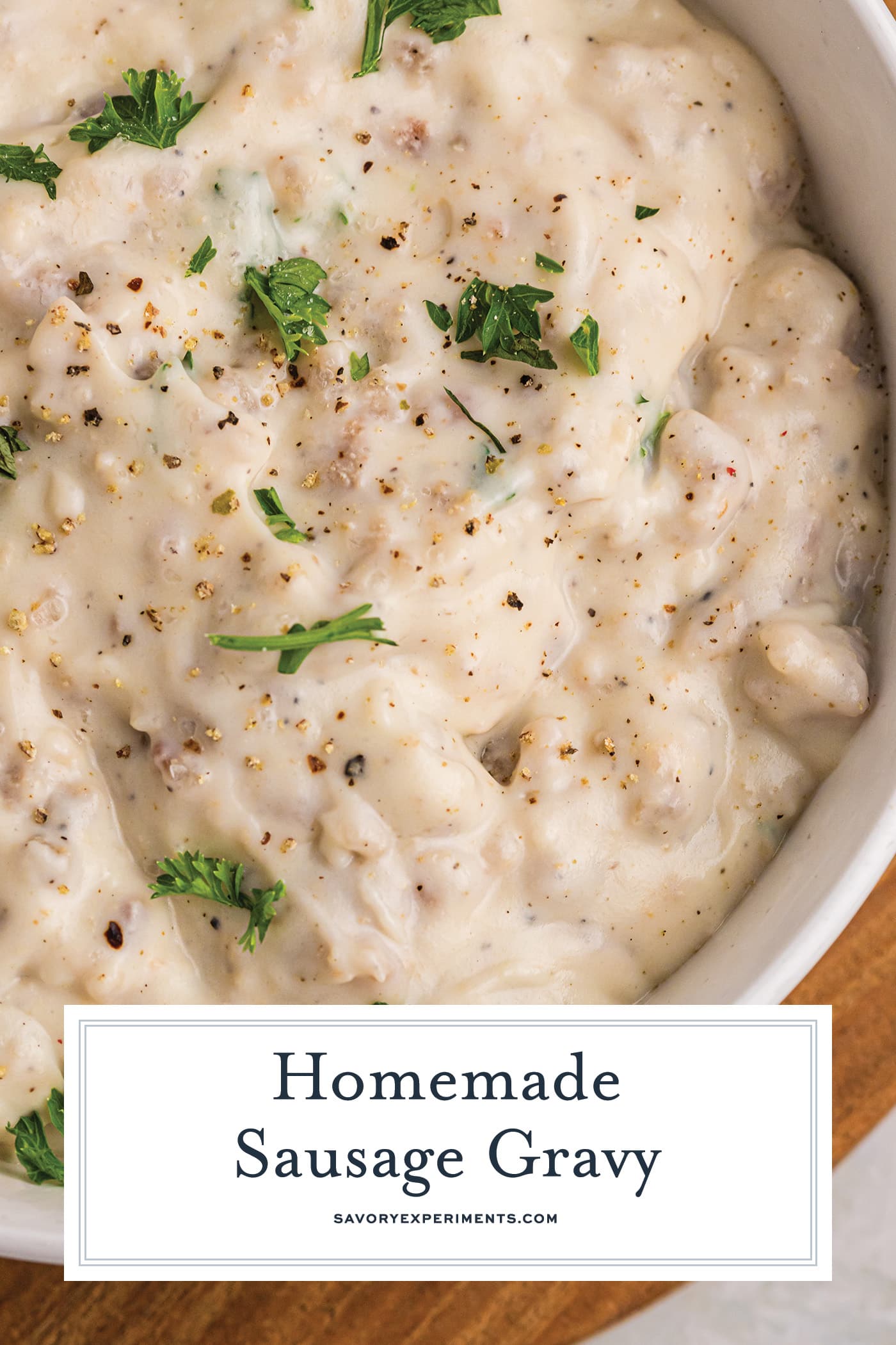 overhead shot of bowl of sausage gravy with text overlay for pinterest