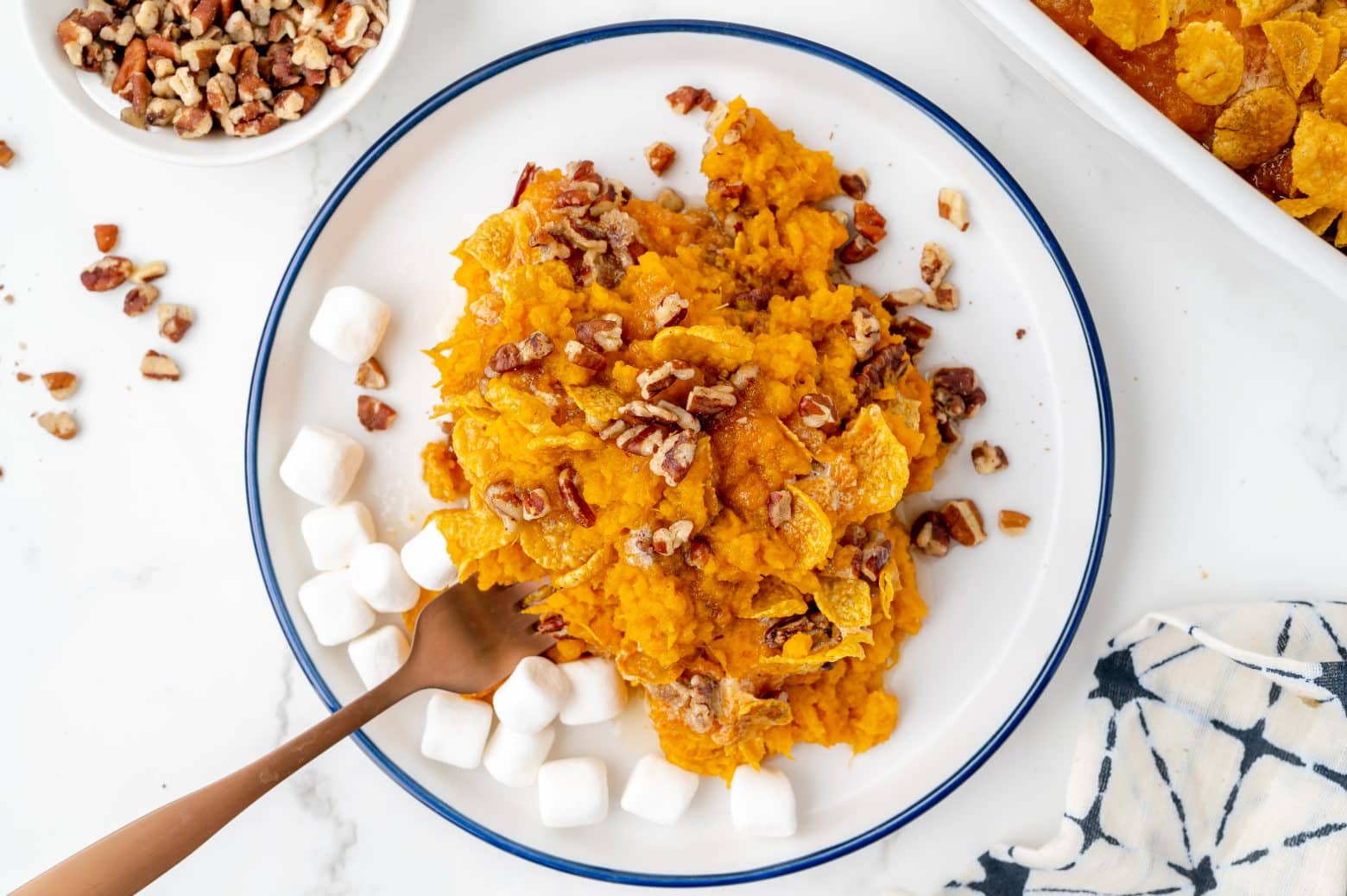 fork digging into sweet potato casserole