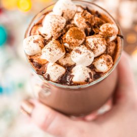 hand holding mug of hot chocolate