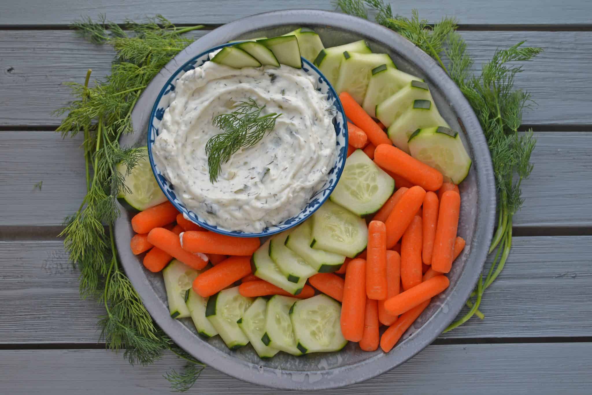 overhead serving greek sauce with veggies 