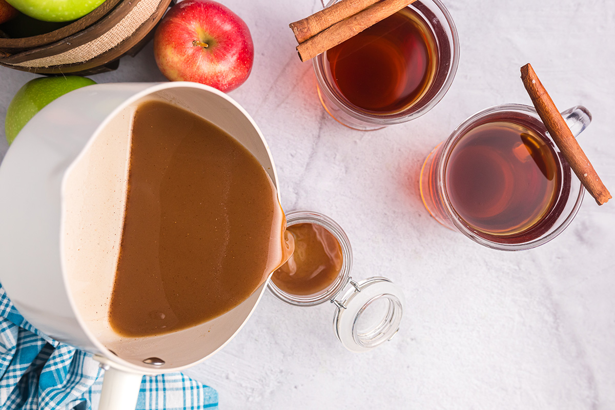 overhead shot of apple cider syrup poured into jar