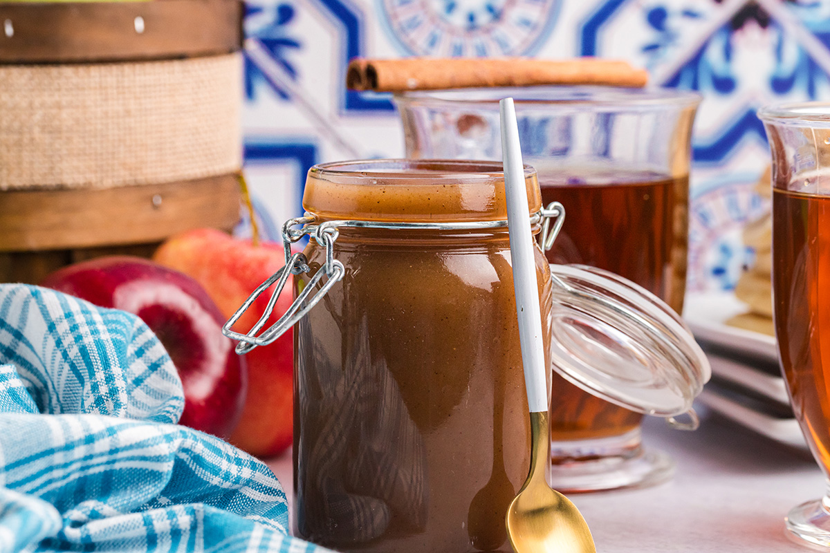 straight on shot of jar of apple cider syrup with spoon