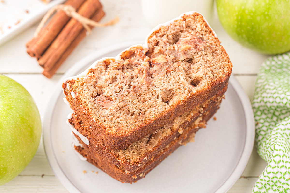 angled shot of apple bread slices stacked on plate