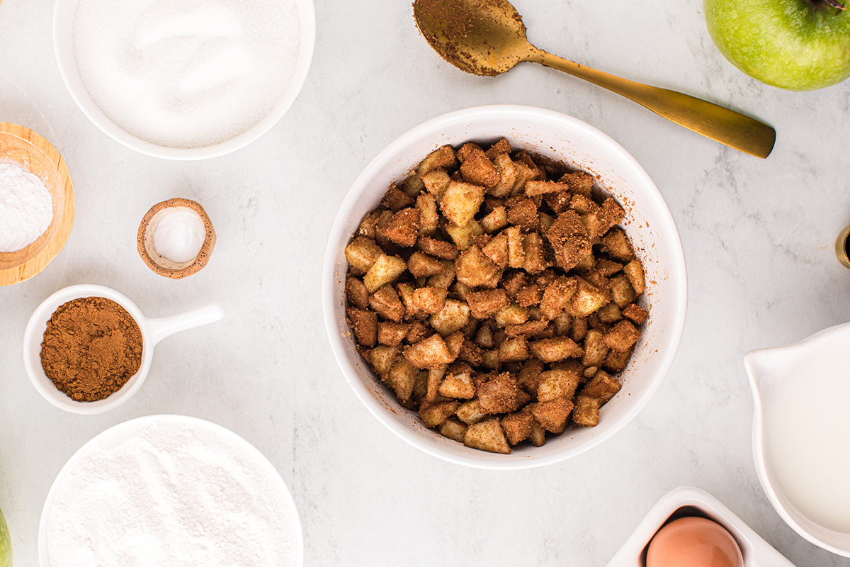 bowl of apples tossed in sugar and cinnamon