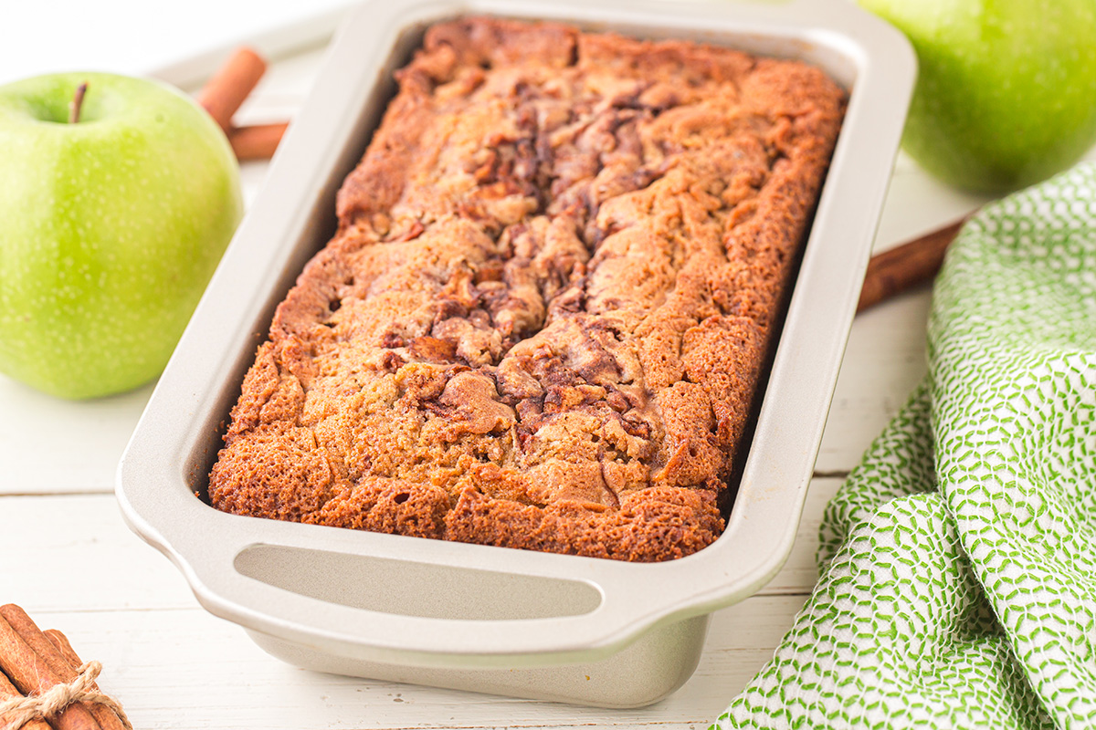 angled shot of baked apple bread in pan