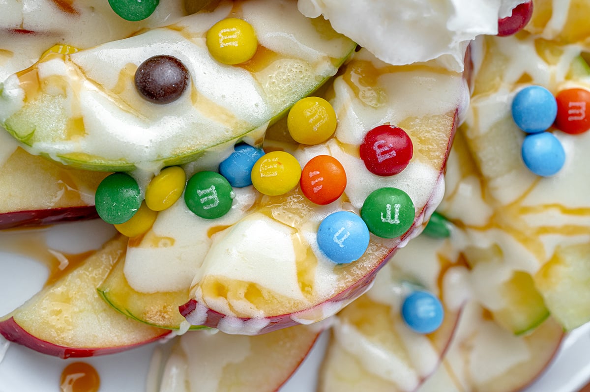 close up of apple slices covered in caramel sauce and marshmallow creme