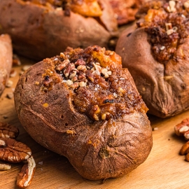 angled shot of stuffed sweet potatoes on board