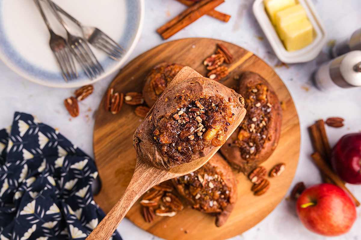 overhead shot of wooden spoon holding stuffed sweet potato