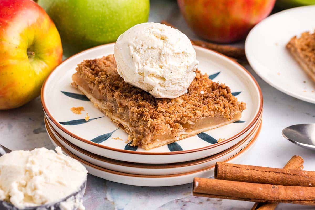 angled shot of apple slab pie topped with ice cream