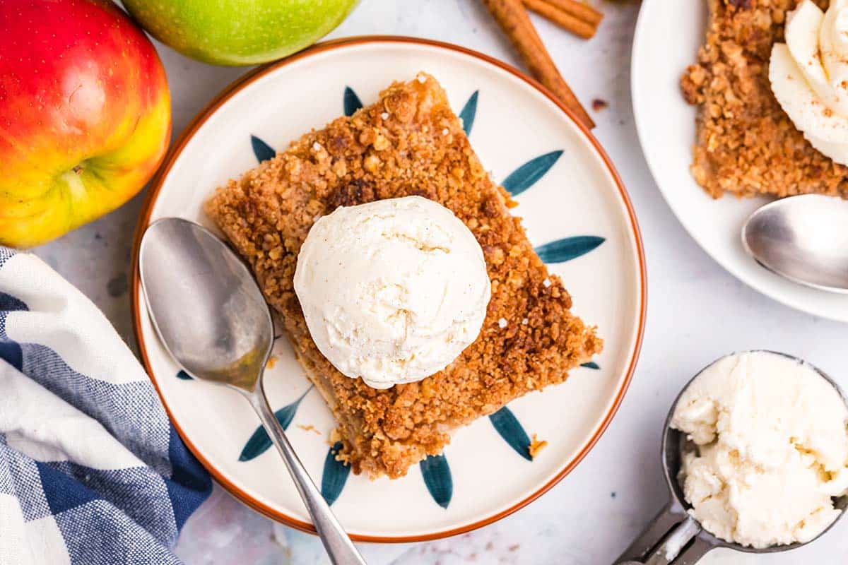 overhead shot of slice of apple pie topped with ice cream