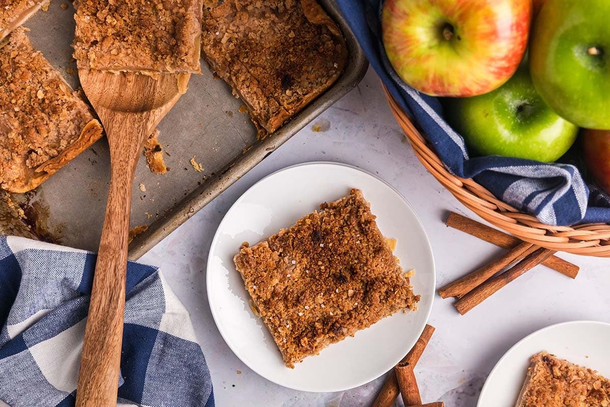 overhead shot of slice of apple slab pie on plate