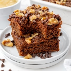 two brownies stacked on a white plate