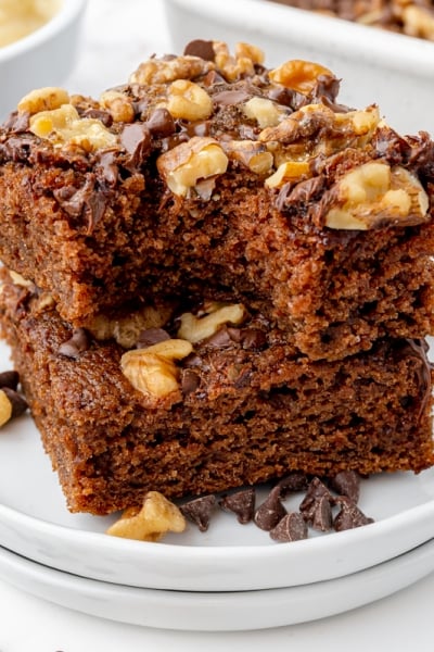 two brownies stacked on a white plate