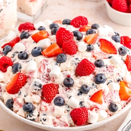 angled shot of bowl of berry cheesecake salad
