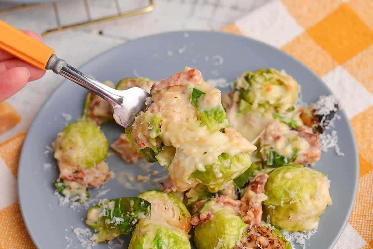 close up of brussels sprouts au gratin on a fork